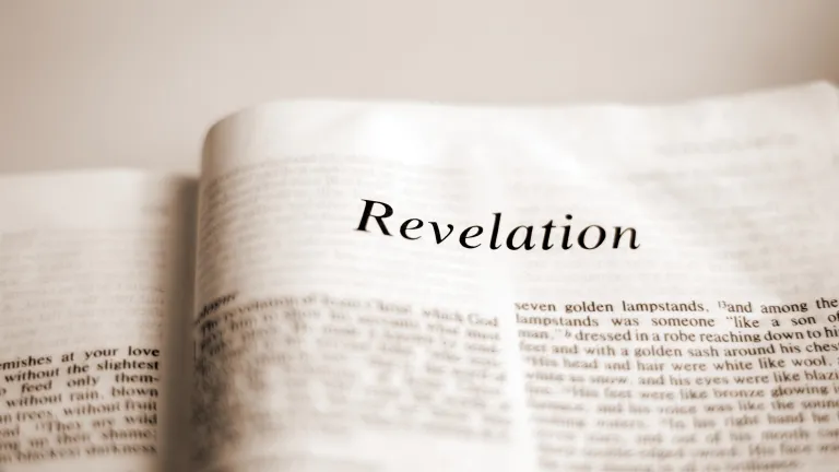 A Bible opened to the book of Revelation.